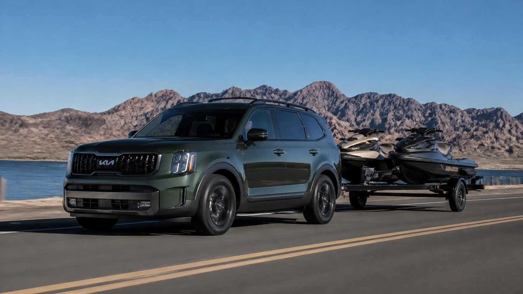 2027 Kia Telluride Hybrid towing jet skis in the desert